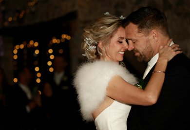 A%20couple%20dancing%20in%20a%20darkened%20room.%20The%20fairy%20lights%20twinkling%20behind%20them.